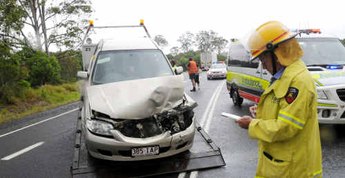 A Gympie firefighter checks his notes as a car is towed near Whites Bridge yesterday. A Gympie firefighter checks his notes as a car is towed near Whites Bridge yesterday.